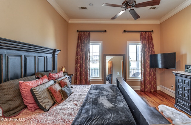 bedroom featuring ceiling fan, crown molding, and hardwood / wood-style floors