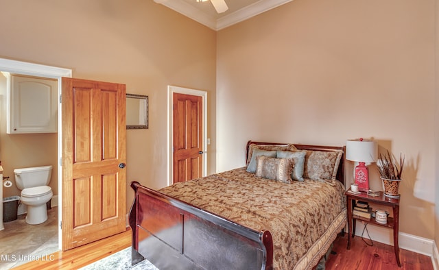 bedroom featuring connected bathroom, ceiling fan, hardwood / wood-style flooring, and ornamental molding