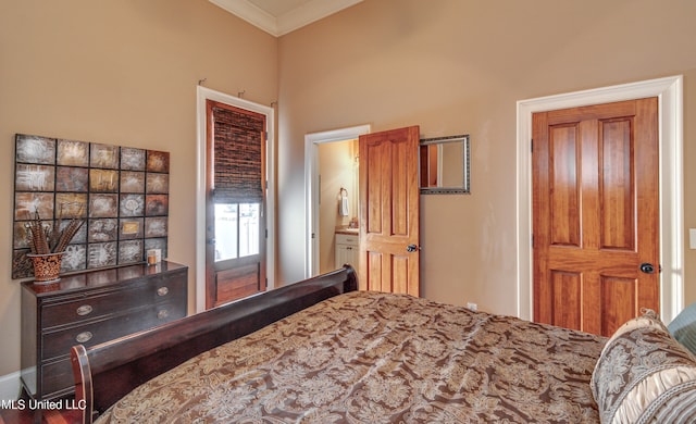 bedroom featuring crown molding and ensuite bathroom