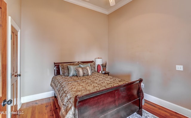 bedroom with crown molding and light wood-type flooring