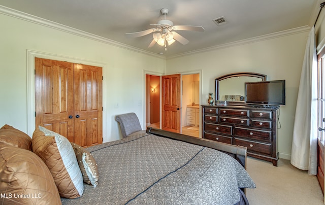 carpeted bedroom featuring crown molding, a closet, and ceiling fan