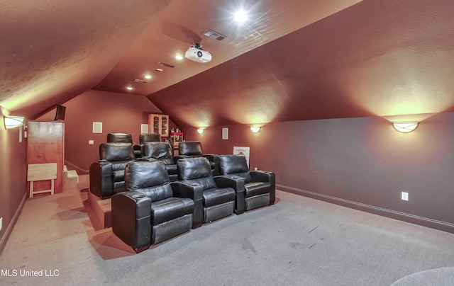 carpeted home theater room featuring lofted ceiling