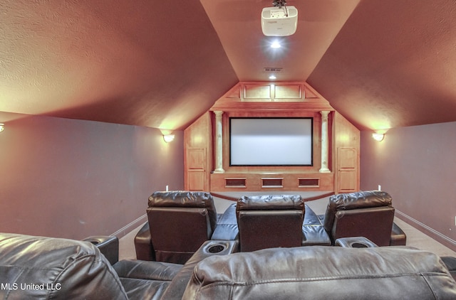 cinema room with lofted ceiling, a textured ceiling, and carpet