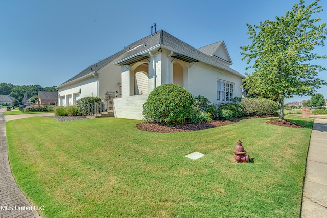 view of side of home featuring a lawn