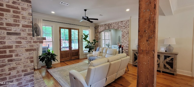 133 Sycamore Rdg, Madison, MS 39110 - living room featuring light wood-style floors, ceiling fan, brick wall, crown molding, and plenty of natural light
