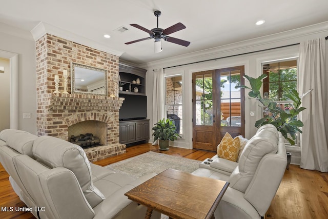 133 Sycamore Rdg, Madison, MS 39110 - living area featuring light wood-style floors, crown molding, ceiling fan, a brick fireplace, and recessed lighting