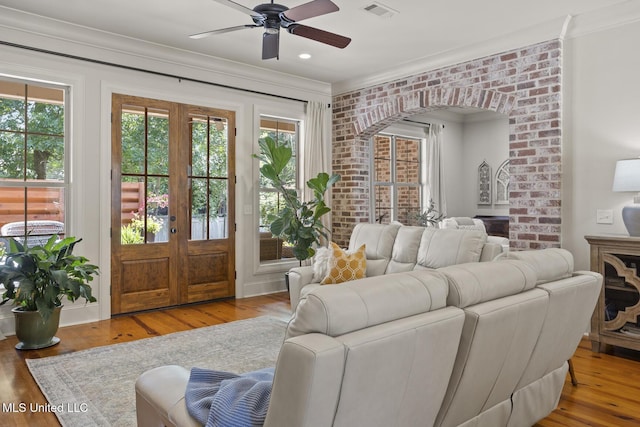 133 Sycamore Rdg, Madison, MS 39110 - living area featuring french doors, arched walkways, ceiling fan, wood finished floors, and crown molding