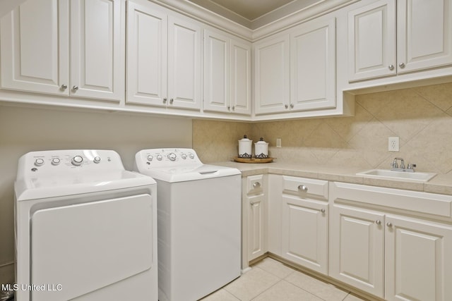 133 Sycamore Rdg, Madison, MS 39110 - washroom featuring cabinet space, separate washer and dryer, and light tile patterned floors