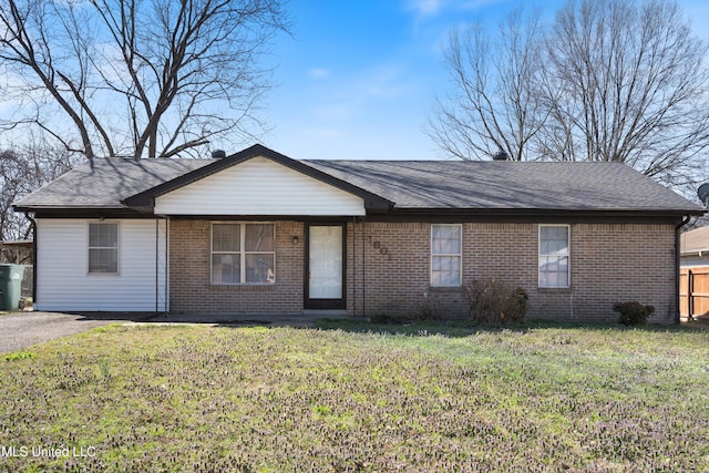 ranch-style house with a front lawn, brick siding, and aphalt driveway