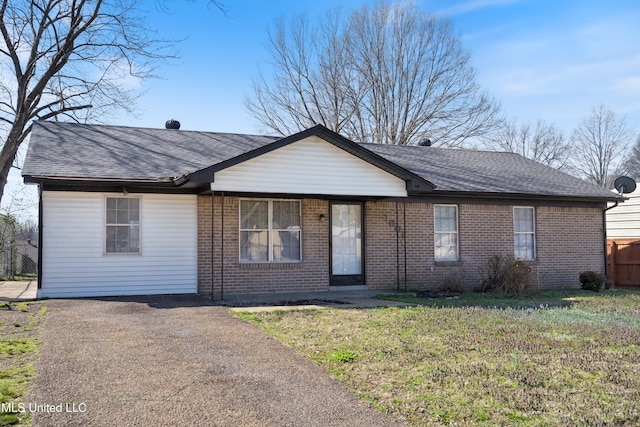 ranch-style house featuring brick siding, roof with shingles, a front lawn, and fence