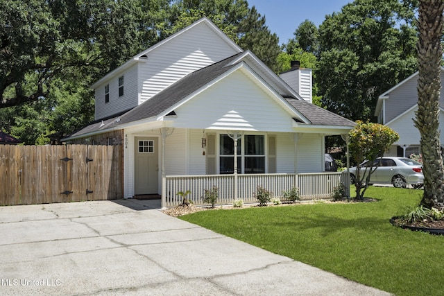 4504 E Magnolia Cv, Diberville, MS 39540 - view of front of property with a porch, a shingled roof, a chimney, and driveway