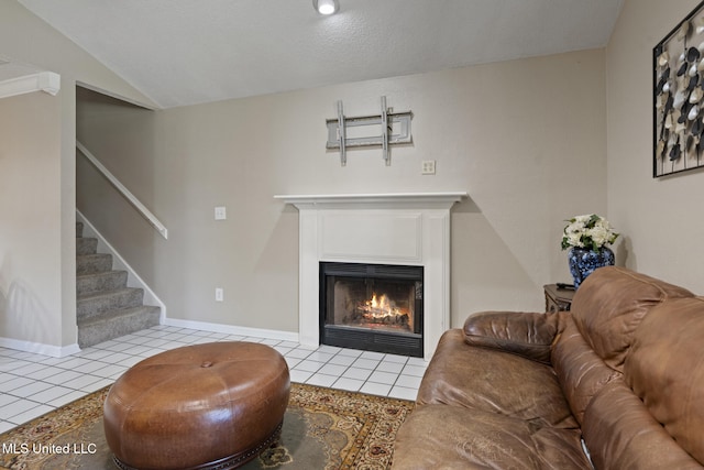 4504 E Magnolia Cv, Diberville, MS 39540 - tiled living room with stairway, a fireplace with flush hearth, vaulted ceiling, and baseboards