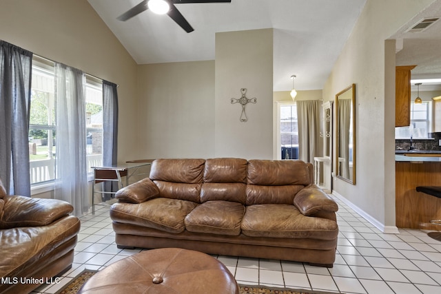4504 E Magnolia Cv, Diberville, MS 39540 - living area with ceiling fan, light tile patterned floors, healthy amount of natural light, and vaulted ceiling