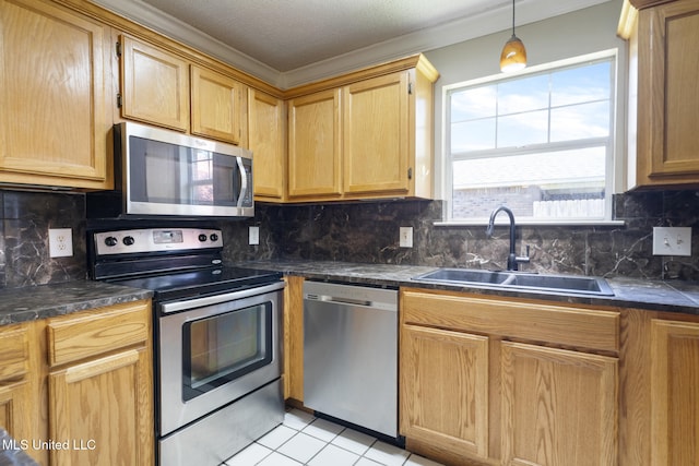 4504 E Magnolia Cv, Diberville, MS 39540 - kitchen featuring stainless steel appliances, a sink, light tile patterned floors, decorative backsplash, and crown molding