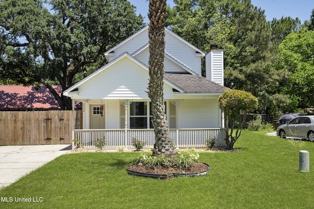 4504 E Magnolia Cv, Diberville, MS 39540 - view of front facade with a porch, a shingled roof, and a chimney