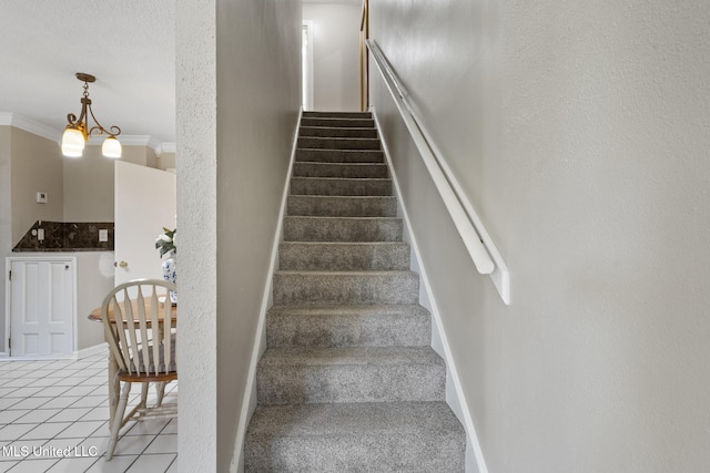 4504 E Magnolia Cv, Diberville, MS 39540 - staircase with ornamental molding, a chandelier, and tile patterned floors