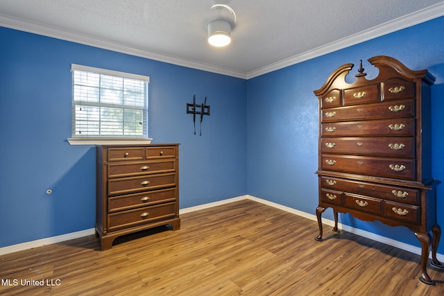 4504 E Magnolia Cv, Diberville, MS 39540 - bedroom featuring ornamental molding, wood finished floors, baseboards, and a textured ceiling
