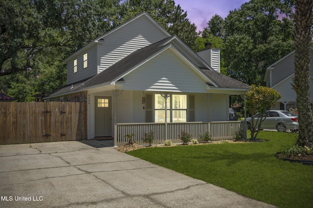 4504 E Magnolia Cv, Diberville, MS 39540 - view of front of home featuring a porch, a chimney, and roof with shingles