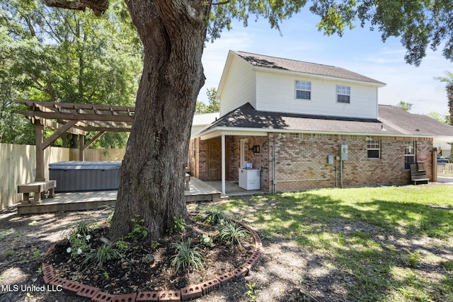 4504 E Magnolia Cv, Diberville, MS 39540 - rear view of house featuring a hot tub, a deck, and brick siding