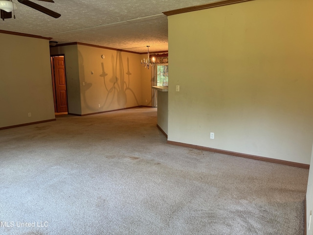 390 Green Rd, Yazoo City, MS 39194 - carpeted spare room featuring a textured ceiling, ceiling fan with notable chandelier, baseboards, and ornamental molding