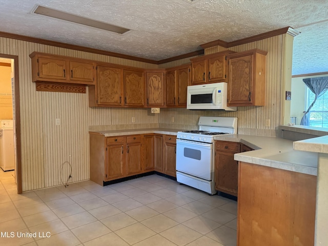390 Green Rd, Yazoo City, MS 39194 - kitchen featuring washer / clothes dryer, white appliances, a peninsula, crown molding, and light countertops