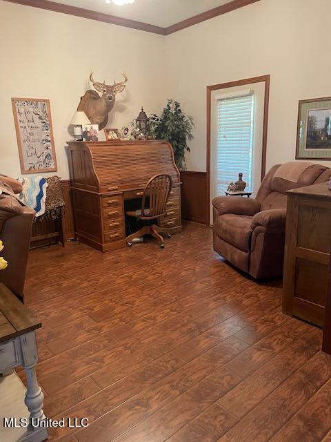 home office featuring hardwood / wood-style flooring, a wainscoted wall, and ornamental molding