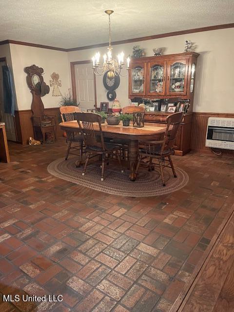 dining space with heating unit, wainscoting, and brick floor