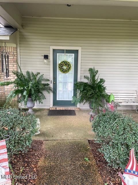 property entrance with brick siding