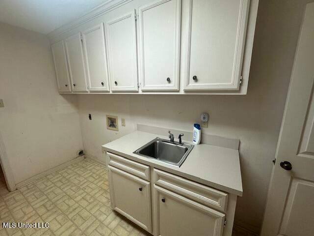 laundry area featuring hookup for a washing machine, cabinet space, hookup for an electric dryer, and a sink