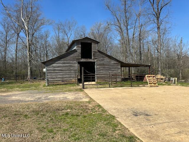 view of barn with fence