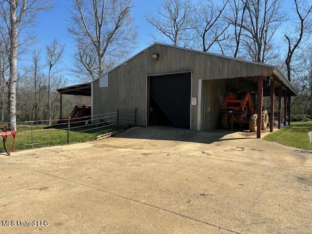 exterior space featuring driveway and fence