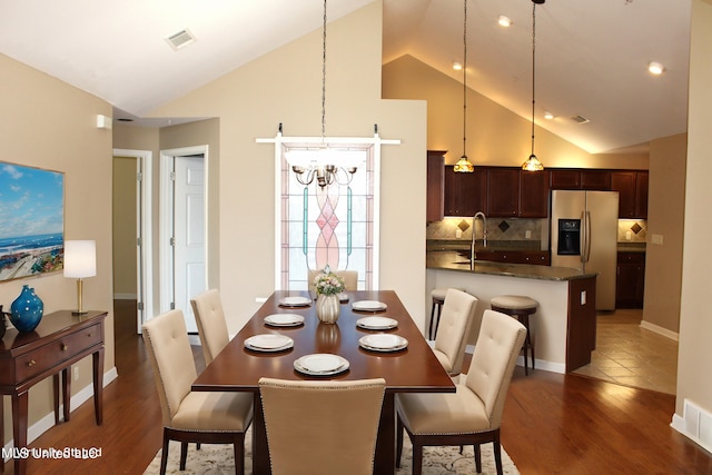 8855 Parkview Oaks Cir, Olive Branch, MS 38654 - dining room featuring high vaulted ceiling, a notable chandelier, dark wood finished floors, and visible vents