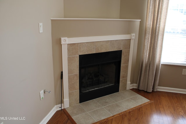 8855 Parkview Oaks Cir, Olive Branch, MS 38654 - details with baseboards, wood finished floors, and a fireplace