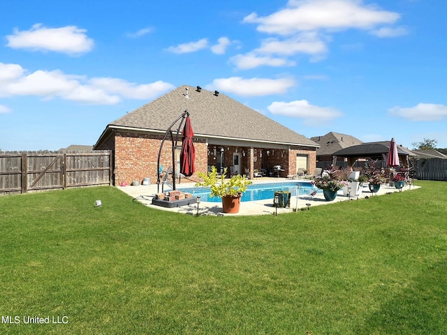 rear view of house featuring a fenced in pool, a patio area, a gazebo, and a yard