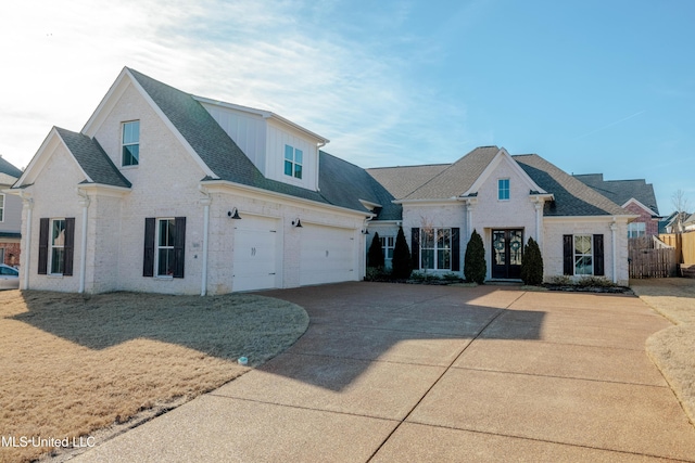 view of front of home featuring concrete driveway, an attached garage, brick siding, and roof with shingles