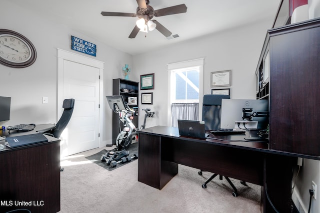 home office with visible vents, carpet floors, and ceiling fan