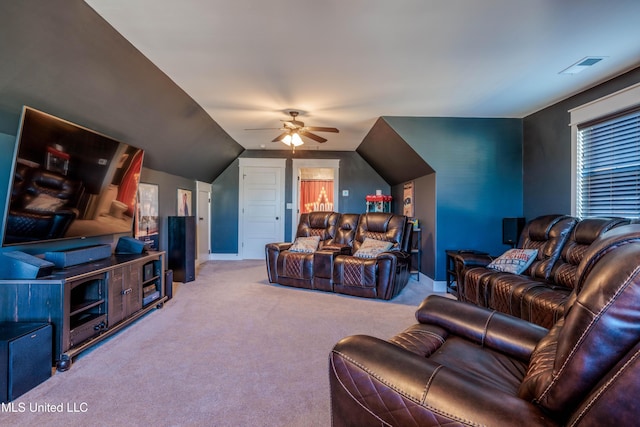 carpeted living area with visible vents, baseboards, ceiling fan, and vaulted ceiling