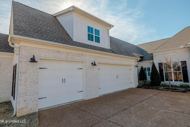 view of home's exterior featuring concrete driveway, brick siding, and a shingled roof