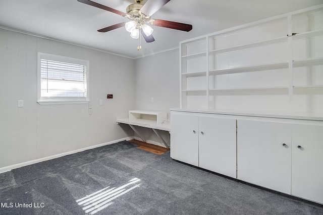 unfurnished bedroom featuring dark carpet, ceiling fan, and ornamental molding