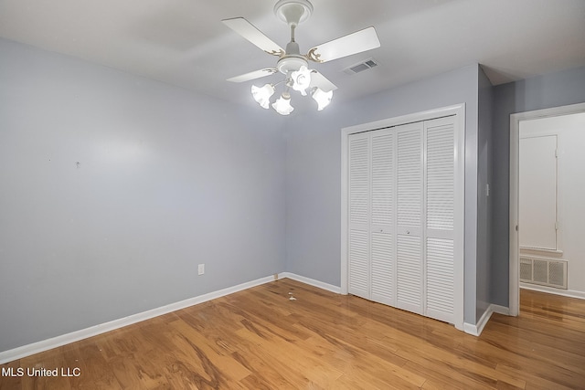 unfurnished bedroom featuring ceiling fan, a closet, and light hardwood / wood-style floors