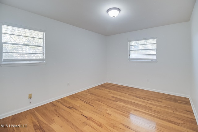 unfurnished room with light wood-type flooring