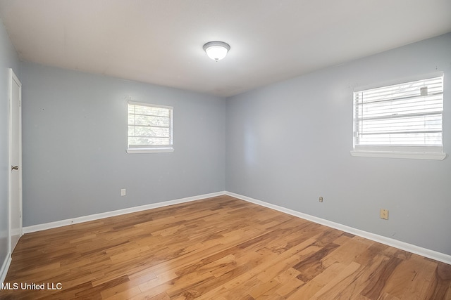 spare room with hardwood / wood-style floors