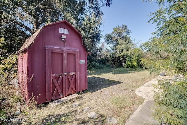 view of outbuilding featuring a lawn