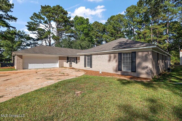 125 Lakeview Dr, Canton, MS 39046 - ranch-style house featuring an attached garage, a front lawn, brick siding, and concrete driveway