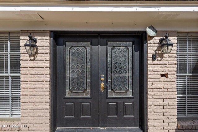 125 Lakeview Dr, Canton, MS 39046 - property entrance featuring french doors and brick siding