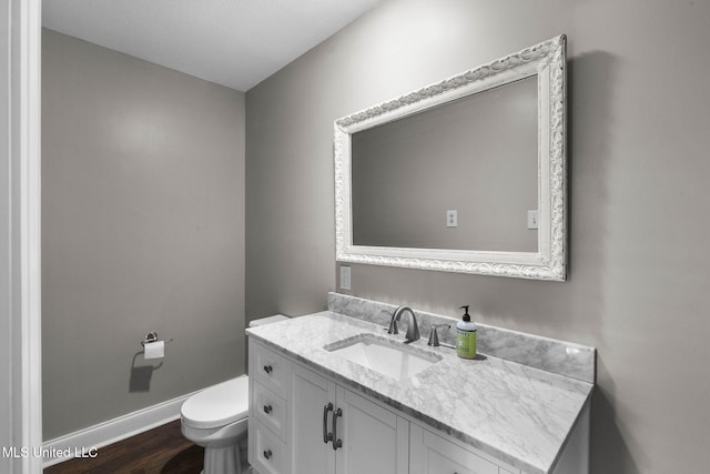 125 Lakeview Dr, Canton, MS 39046 - bathroom featuring baseboards, wood finished floors, vanity, and toilet
