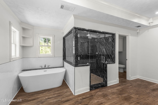 125 Lakeview Dr, Canton, MS 39046 - full bath with ornamental molding, toilet, a stall shower, wood finished floors, and a soaking tub