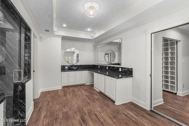 125 Lakeview Dr, Canton, MS 39046 - kitchen with dark wood-style flooring, crown molding, white cabinetry, baseboards, and dark stone counters
