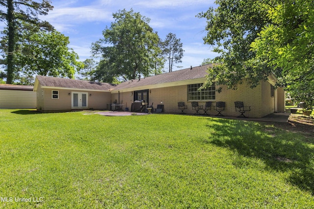 125 Lakeview Dr, Canton, MS 39046 - back of house featuring french doors, a patio area, a yard, and brick siding