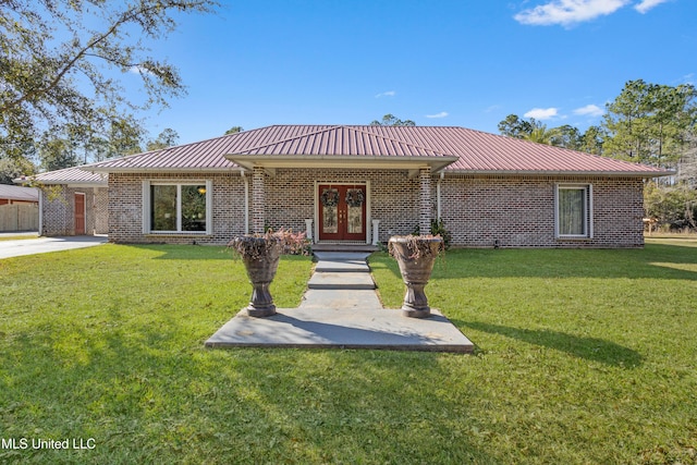 ranch-style house featuring french doors and a front lawn